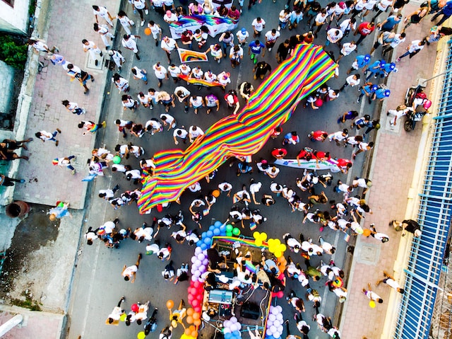 People on the street, LGBTIQ flag.